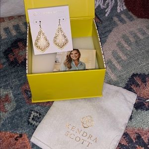 Gold Kendra Scott earrings.